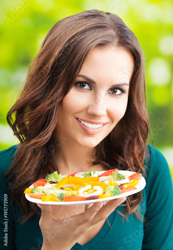 Young woman with salad, outdoors
