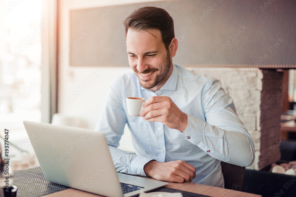 Portrait of young man sitting at desk in the office. Portrait of young man sitting at desk in the office.