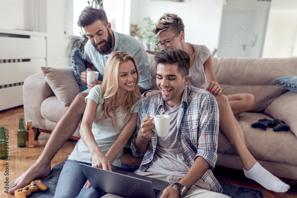 Happy friends with laptop watching a funny video. Happy friends with laptop watching a funny video.