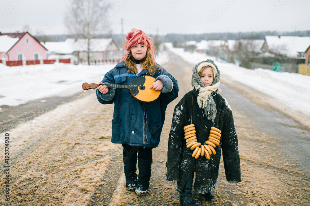 Funny kids outdoor. Youth in village. Russian style traditional clothes.  Two little girls bizarre unusual strange portrait. Children wearing adult  oversized clothing. Traditions in country. Childhood. Stock Photo | Adobe  Stock