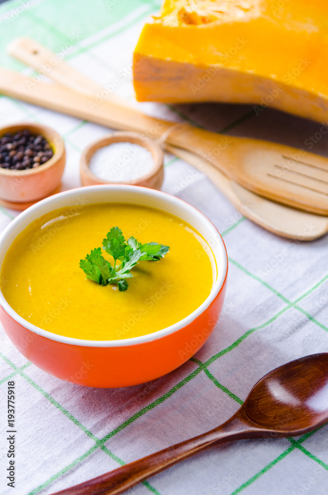 Pumpkin soup served on the table in bowl Pumpkin soup served on the table in bowl