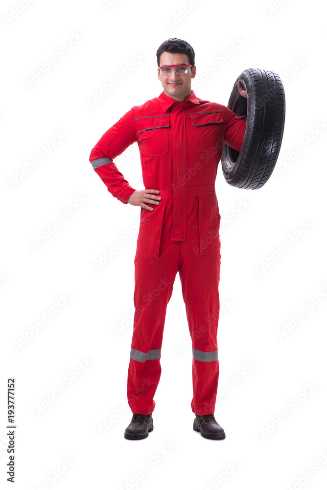 Young tyre repairman in red coveralls isolated on white backgrou Young tyre repairman in red coveralls isolated on white backgrou