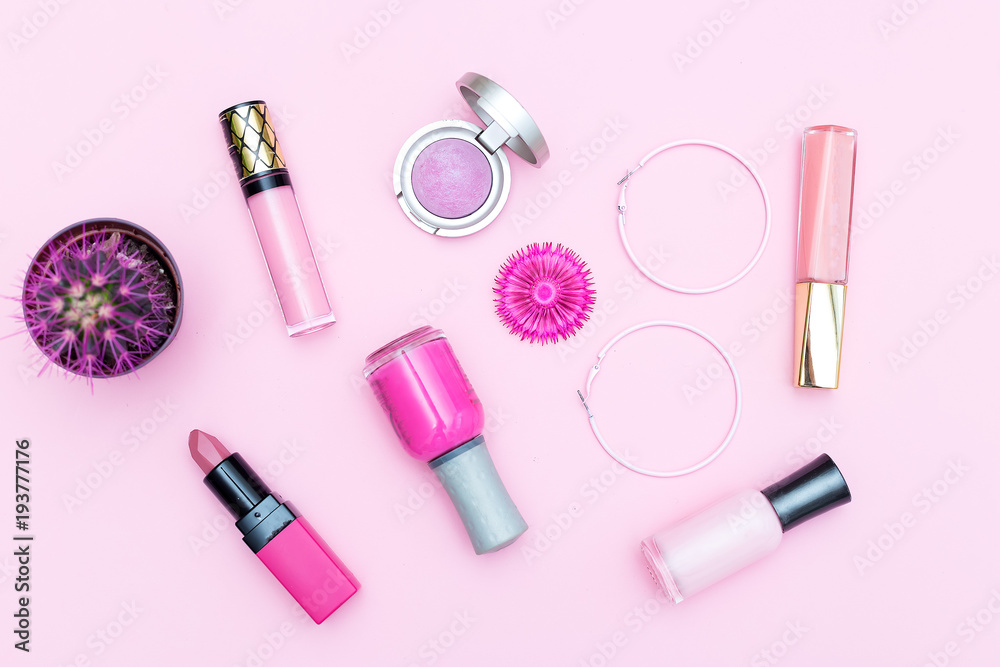 Pink cosmetics on a pink background and a pink cactus. Monochrome color