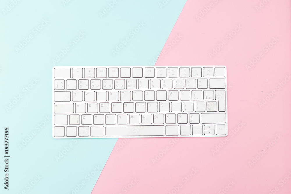 A white keyboard on a two pastel color background. Flat lay Stock Photo |  Adobe Stock