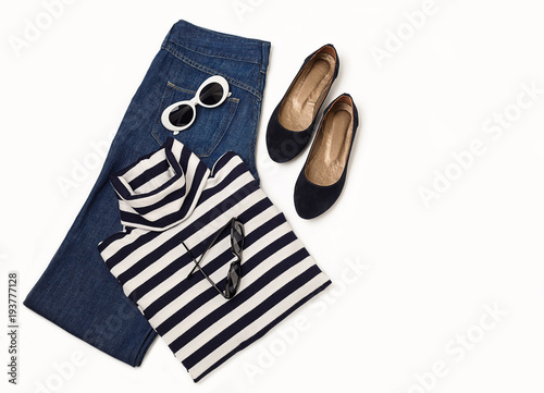 Fashion set of blue jeans, striped sweater, shoes and sunglsses on white background.