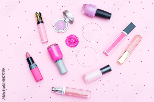 Pink make-up cosmetics on a pink background. Flat lay