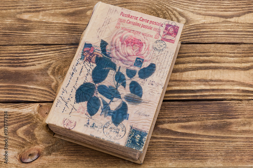 The book on the table is made of textured boards of dark wood.