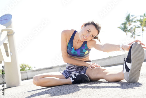 Jogger woman stretching our after running