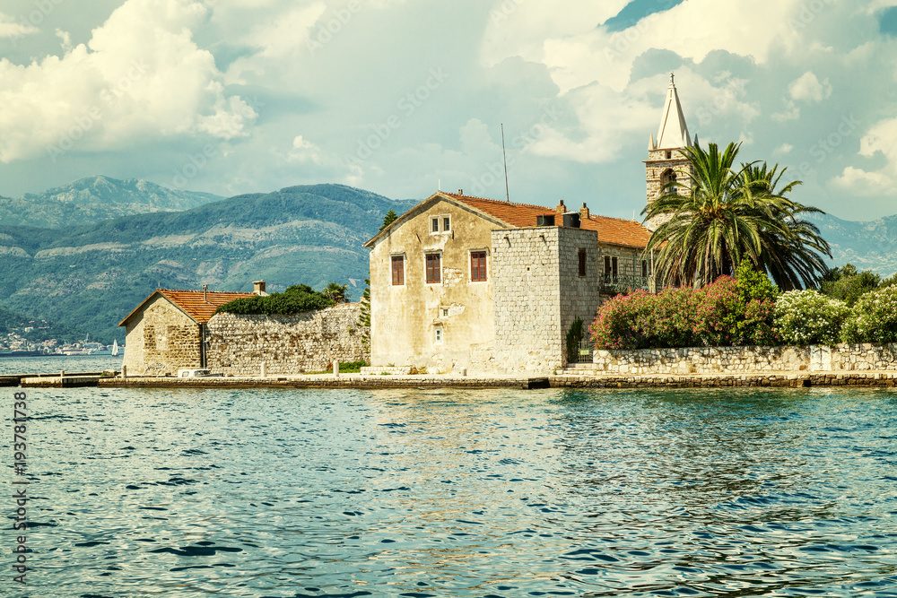 Island in the sea with an old building and beautiful vegetation