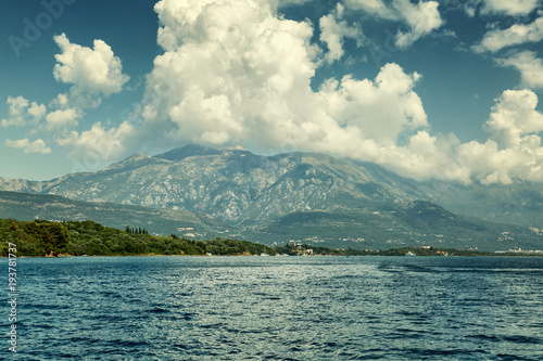 Beautiful mountain landscape cumulus clouds blue sky sea