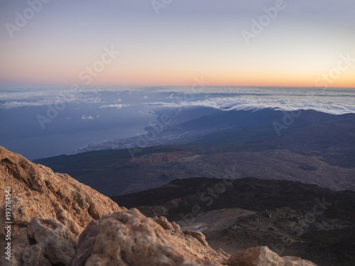 red glow before sunrise with vulcanic landscape view from the top of pico del teide vulcano highest spanish mountain on tenerife canary island