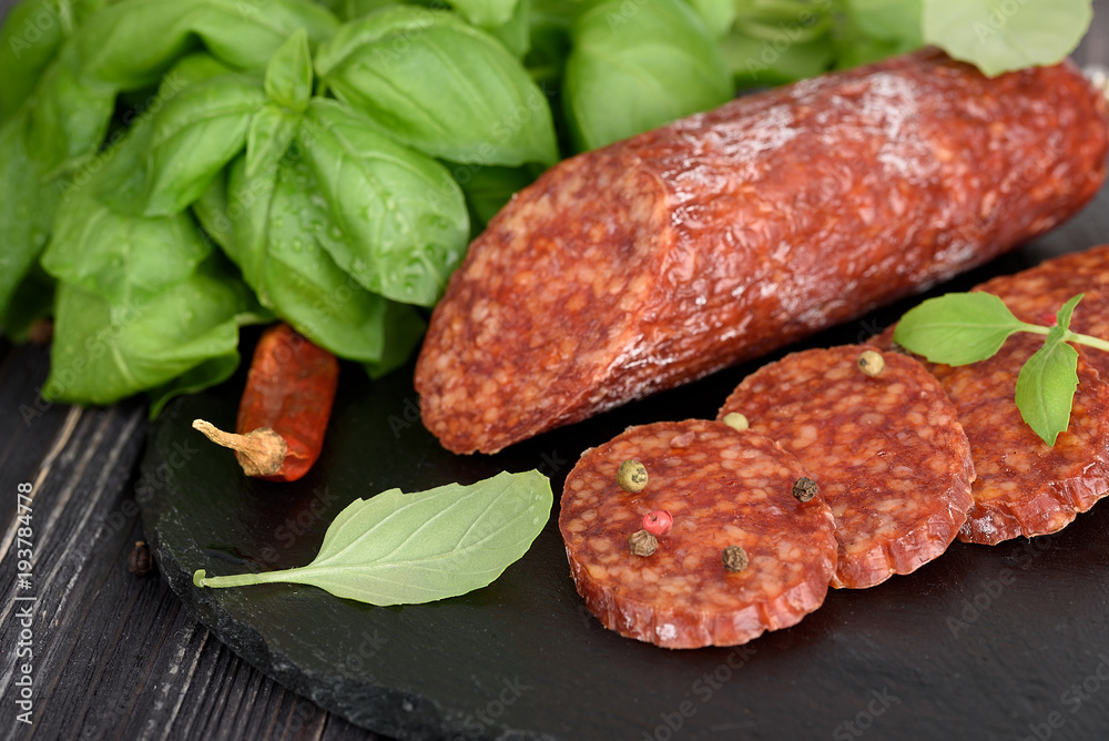 Delicious salami with basil , selective focus Delicious salami with basil , selective focus