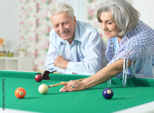 senior couple playing billiard