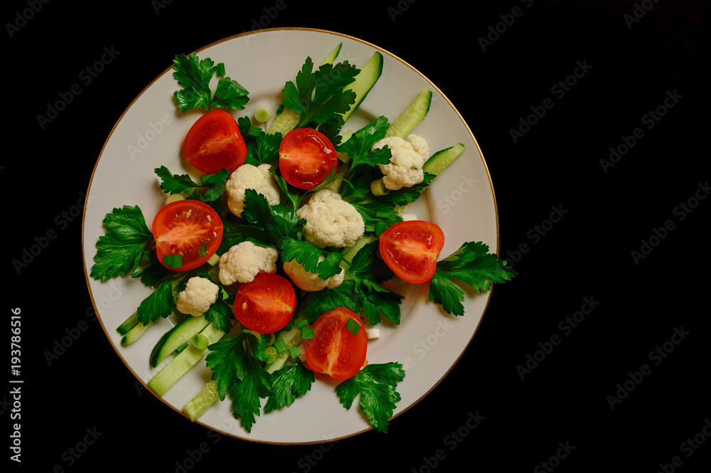 Fresh vegetables salad with white cabbage on black background. Top view Fresh vegetables salad with white cabbage on black background. Top view