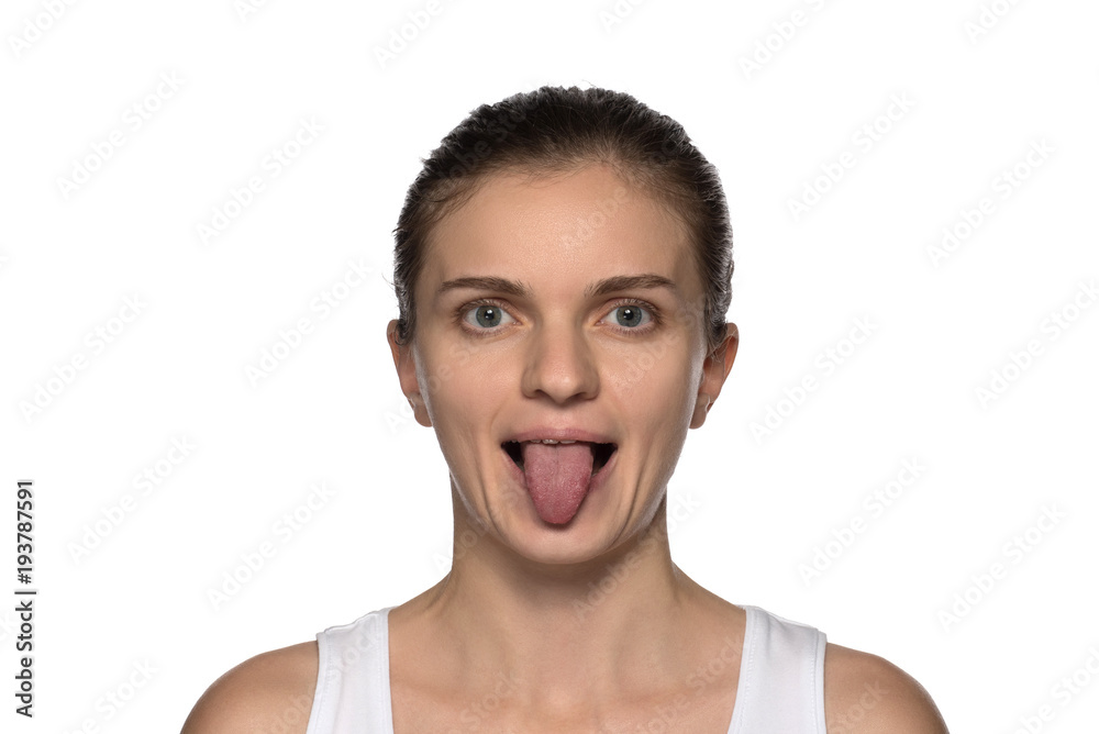 Massage, yoga, gymnastics or rejuvenating exercises for the face makes the girl own hands on a white background Massage, yoga, gymnastics or rejuvenating exercises for the face makes the girl own hands on a white background