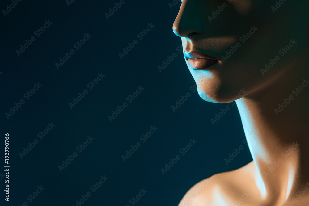 Fragment of a woman's face. Lips of a woman. Profile face on a dark background. Fragment of a woman's face. Lips of a woman. Profile face on a dark background.