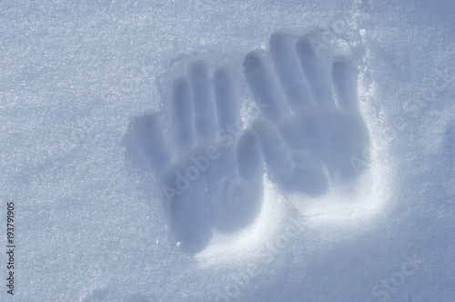 children's hands in the snow.