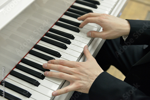 Music. Hands of young pianist