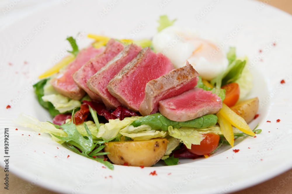 Nicoise salad of rare fried tuna, potato, salad mix and poached egg
