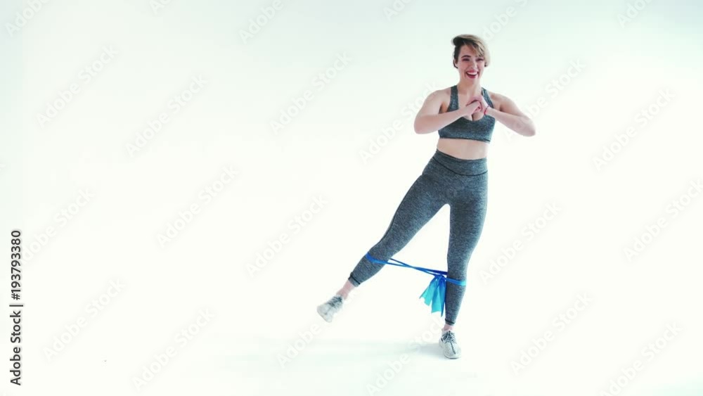 Fitness woman doing exercises with elastic bands on white background Fitness woman doing exercises with elastic bands on white background