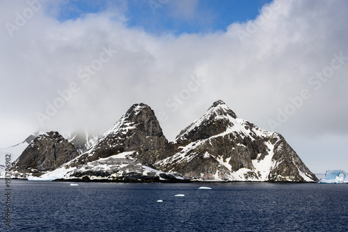 Rocks with snow in sea