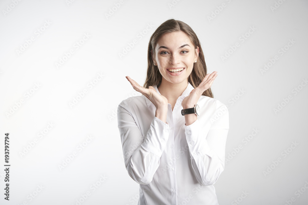Portrait of happy young businesswoman wearing white shirt while standing with her arms rasied and wondering. Isolated on white background. Portrait of happy young businesswoman wearing white shirt while standing with her arms rasied and wondering. Isolated on white background.