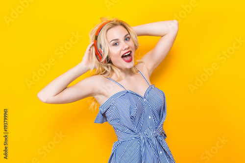 Blonde girl in blue striped blouse with headphones