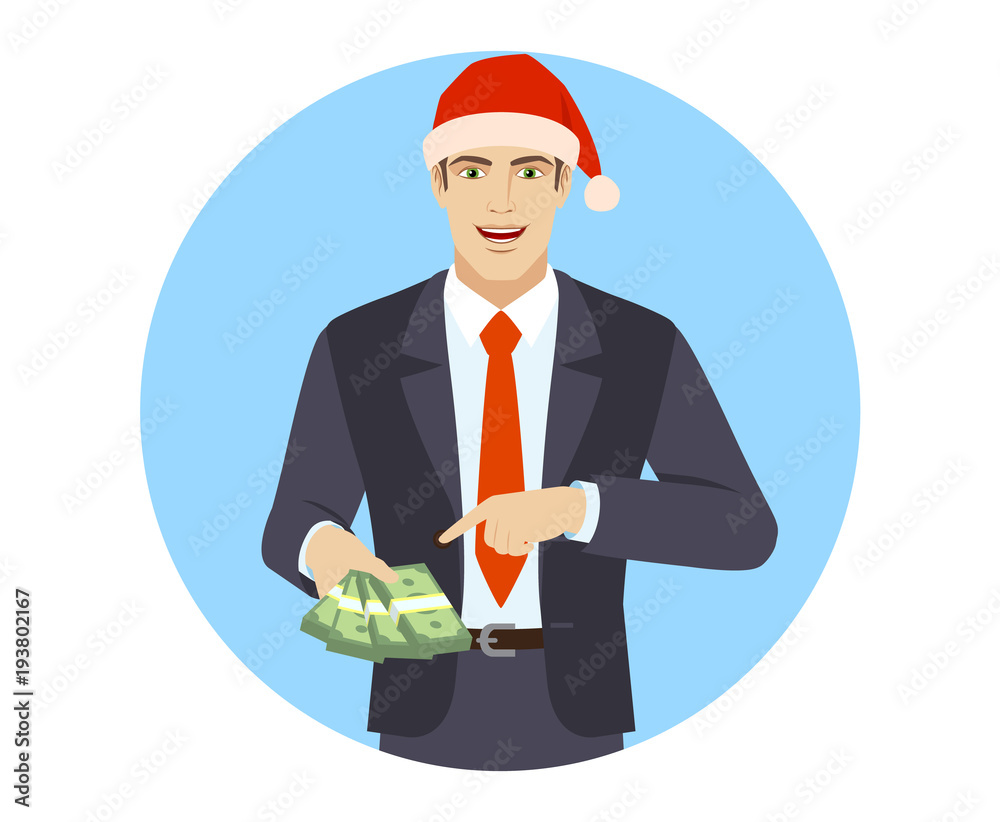 Businessman in Santa hat pointing at money in his hand Businessman in Santa hat pointing at money in his hand