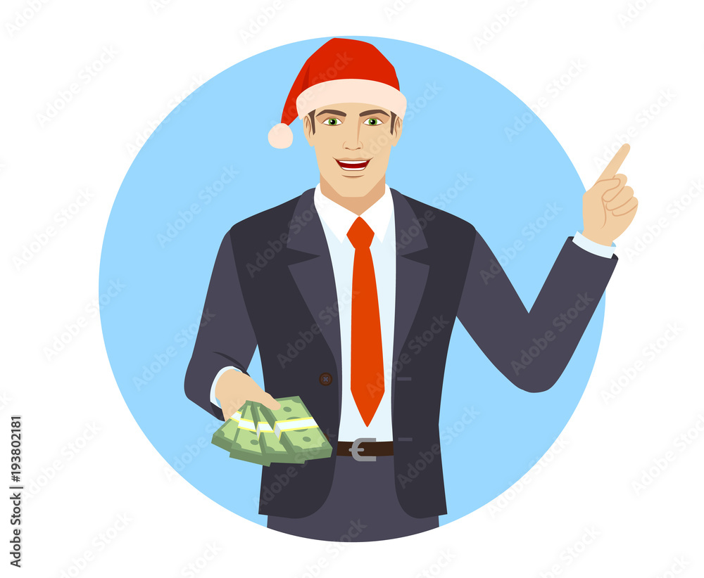 Businessman in Santa hat pointing at money in his hand Businessman in Santa hat pointing at money in his hand