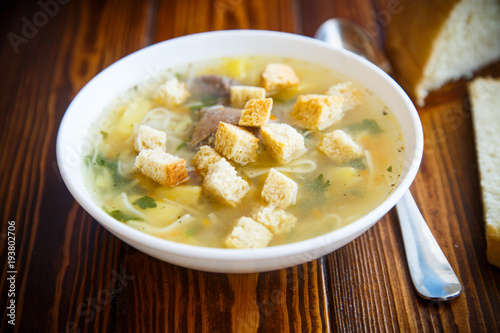 hot chicken soup with homemade noodles and croutons