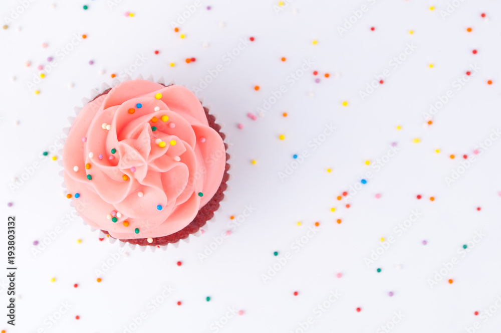 Cupcake red velvet with blue and pink whipped cream decorated with