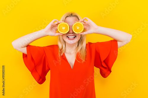 Blonde woman in dress with oranges © Ivan Traimak