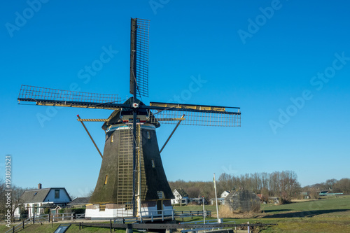 Historical wind mill in a dutch rural landscape