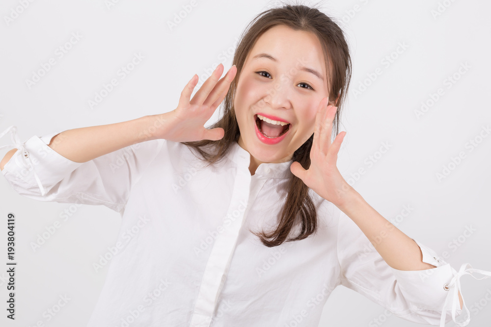 Young happy business woman shout and scream using her hands isolated on white. Young happy business woman shout and scream using her hands isolated on white.