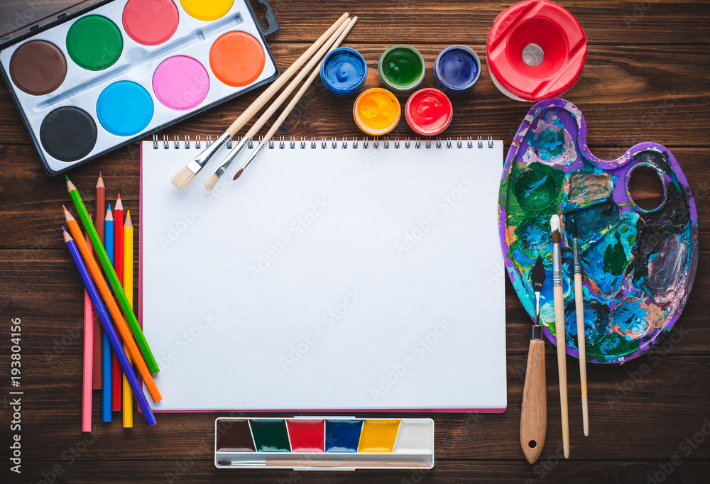 Fototapeta premium Set of paints, pencils, tools for painting and blank white paper sheet