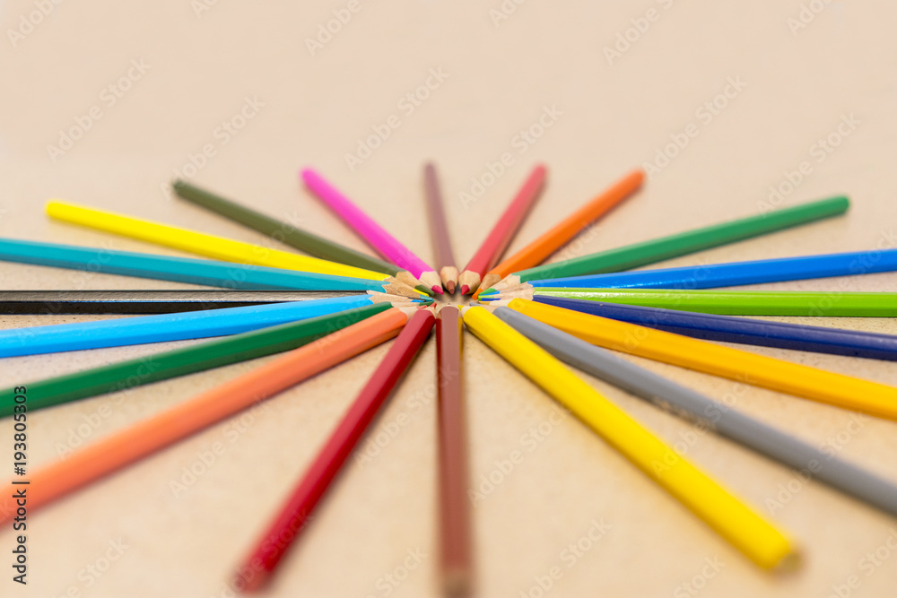 Ring of pencils isolated on a light background. Multicolored pencils