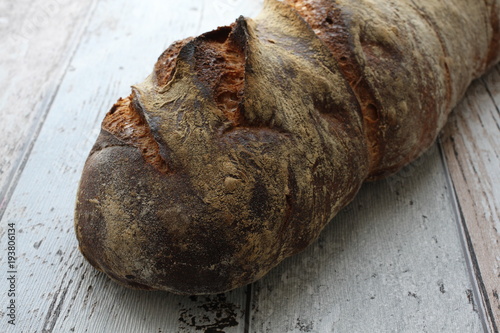 Fresh crusty swiss bread on rustic background
