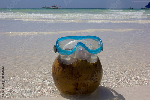 mask for swimming on a coco, on the beach of the island Borakay, Philippines photo