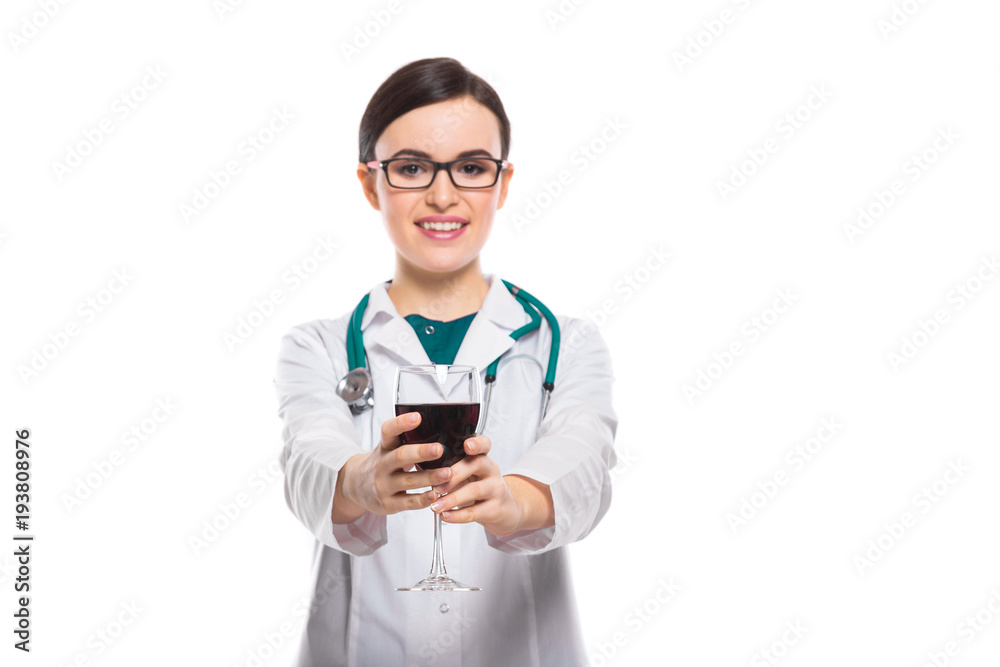 Young woman doctor with stethoscope offering wine in white uniform on white background Young woman doctor with stethoscope offering wine in white uniform on white background