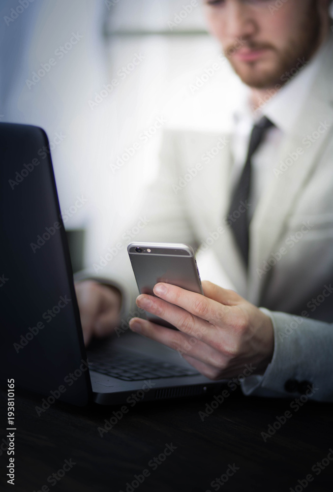 Businessman checking his bank account on cellphone Businessman checking his bank account on cellphone