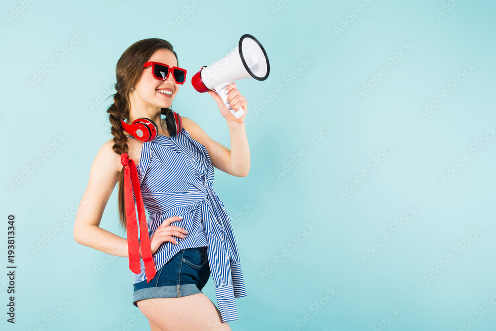 Young sexy woman with headphones and loudspeaker Young sexy woman with headphones and loudspeaker