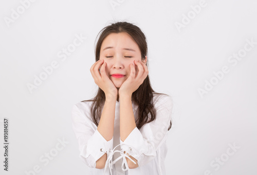 Sad young woman covering her face, crying for problem of expression. Negative feelings concept. 
