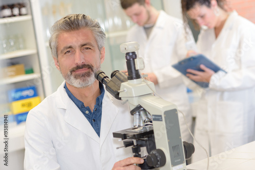 male scientific researcher using microscope in the laboratory