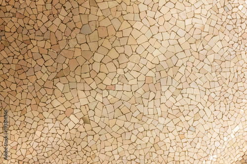 Ceramic tiles background, broken glass mosaic, decoration in Park Guell, Barcelona, Spain. Designed by Gaudi
