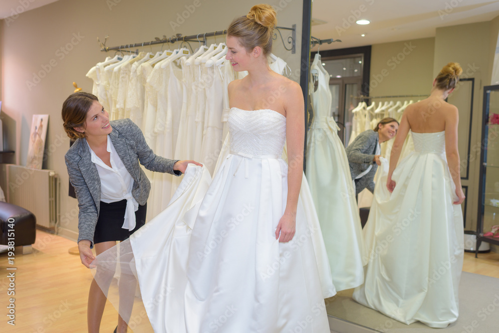 Woman trying on wedding dress Woman trying on wedding dress