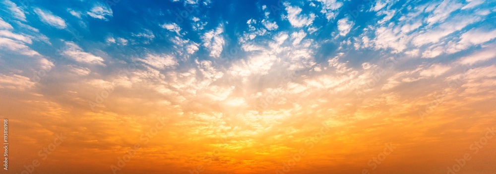 Panorama background of cloudy blue and orange sky