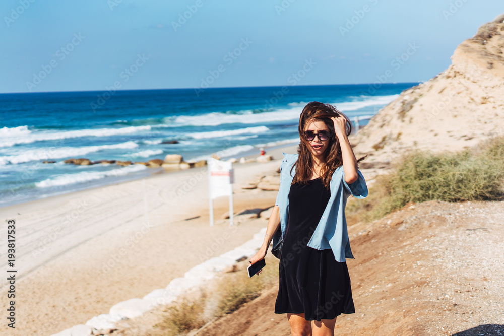 Young beautiful girl posing by the sea Young beautiful girl posing by the sea