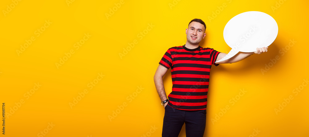 Handsome man in bright T-shirt with speech bubble Handsome man in bright T-shirt with speech bubble