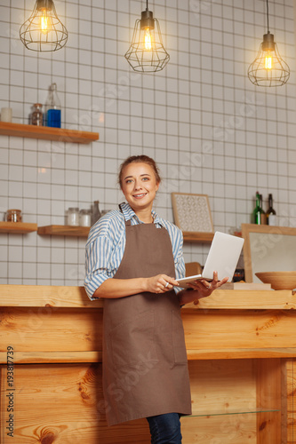 Cheerful intelligent woman looking at you