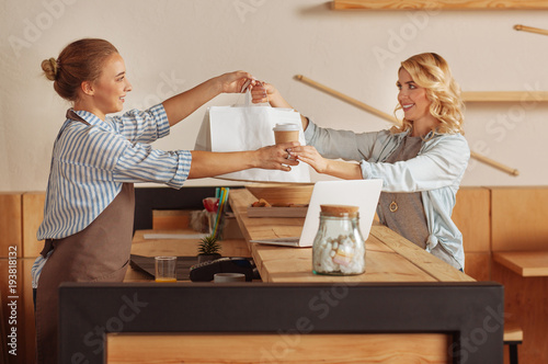 Nice positive woman taking her order